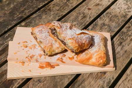 Sugary chocolate pastry on a wooden tableの写真素材