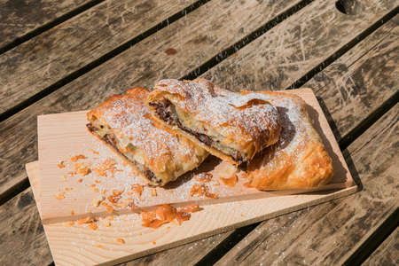 Sugary chocolate pastry on a wooden tableの写真素材