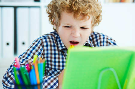 Preteen curly Caucasian boy have nervous breakdown because of difficult large homework. Education,...