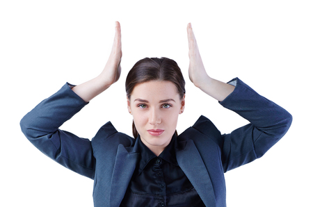 Business woman imitates holding the crown over her head. Leadership, success concept.の写真素材