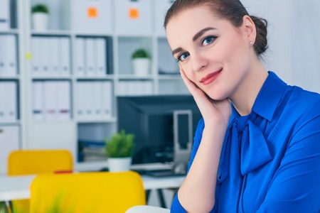 Beautiful smiling businesswoman portrait at workplace look in camera.の写真素材