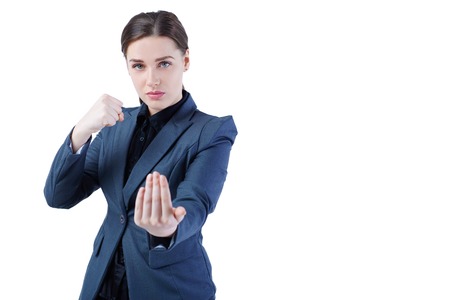 Young caucasian business woman in full length, ready for a fight. Isolated on white background. Strength, power or competition concept imageの写真素材