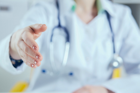 Close up doctor woman stretching hand for handshakeの写真素材