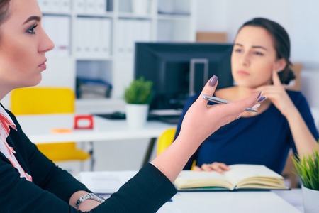 Young female colar smiling during meeting in office conference room. Team work concept.の写真素材