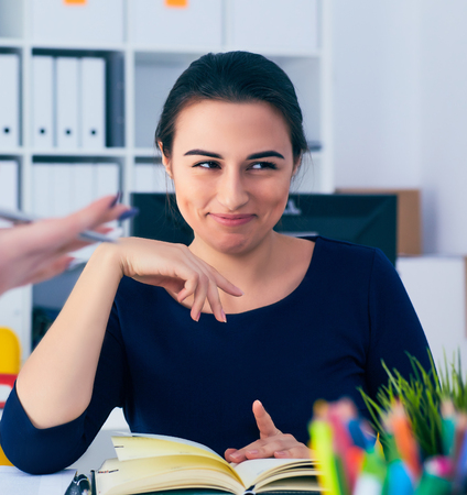 Young female colar smiling during meeting in office conference room. Team work concept.の写真素材