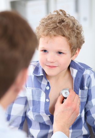 Doctor examining a child patient by stethoscope. Health care concept.の写真素材