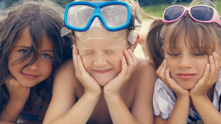 Group of children lying on the beach in summer.の写真素材