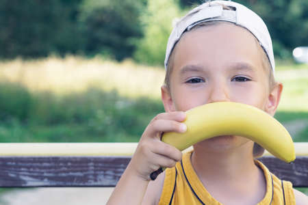 Face of a beautiful young caucasian boy with banana mustacheの写真素材
