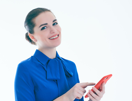 Beauty woman in blue blouse using and reading a smart phone isolated on a white background.の写真素材