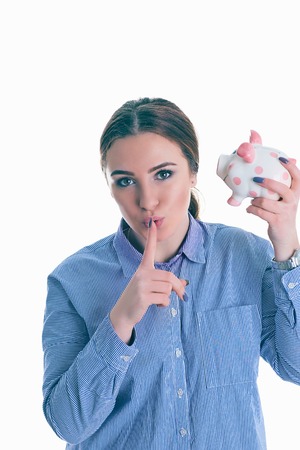 Beautiful Caucasian woman holding index finger at lips, asking to keep silence or not tell anyone...