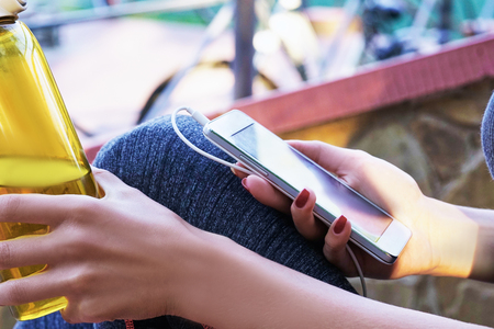 Portrait of young beautiful sportwoman drinking water at summer green park.の写真素材