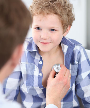 Doctor examining a child patient by stethoscope.  Health care oの写真素材