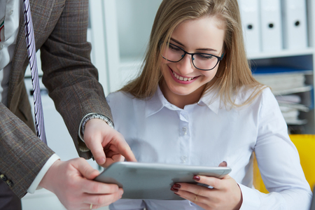 Business team working at office desk and using a digital touch screen tablet.の写真素材