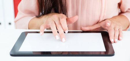 Business woman using digital tablet with blank screen. Just hands at the table.の写真素材