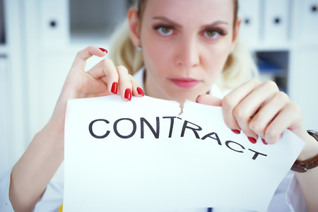 Hands of female medicine doctor ripping contract. Break the rules - failure business concept. Photo with depth of field.の写真素材
