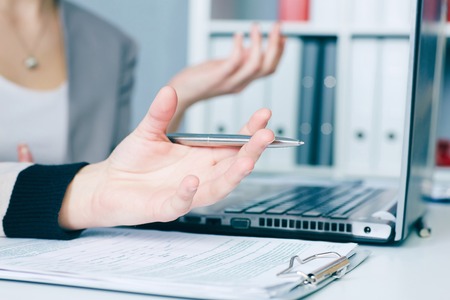 Hands of two business women discussing a contract closeup.の写真素材