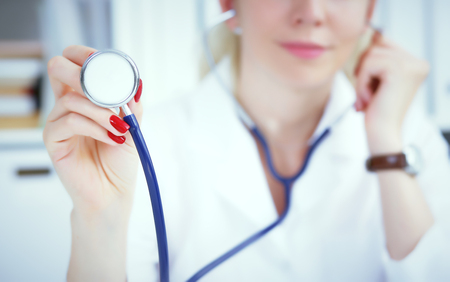Close-up of female doctor hand holdong stethoscope , focus on stethoscope.の写真素材