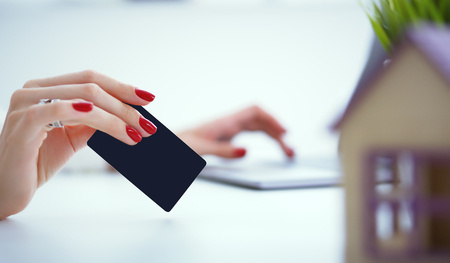 Invest in real estate concept. woman makes a payment with a credit card for the purchase of real estate on credit.の写真素材