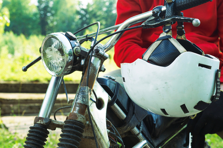 Middle section of enduro racer sitting on his motorcycle.の写真素材