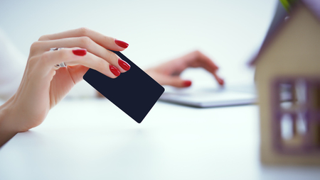 Invest in real estate concept. woman makes a payment with a credit card for the purchase of real estate on credit.の写真素材