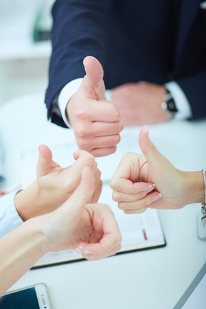 Hands of business team with tumbs up. Business, people, statistics and teamwork concept.の写真素材
