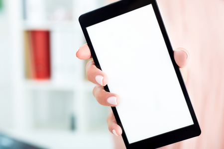 Close up of blank smart phone screen in female hands.の写真素材
