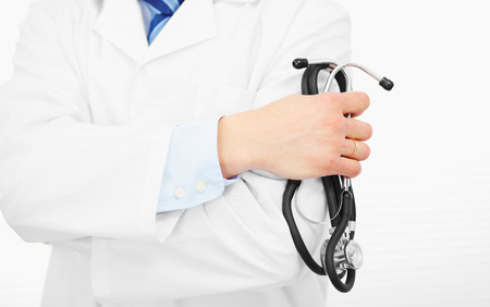 Medical sign - doctor holding stethoscope in hands. Doctor is waiting for patient to examine.の写真素材