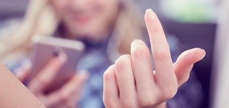 Woman gesturing come here calling you lying on the couch and holding smartphone in hand close-up.の写真素材