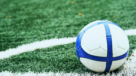 Soccer ball on green football field close-up.の写真素材