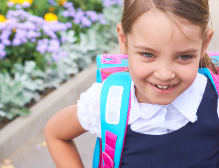 Back to school - lovely schoolgirl on the way to the school.の写真素材