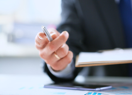 Businessman gives pen offers to sign new job employment contract.の写真素材