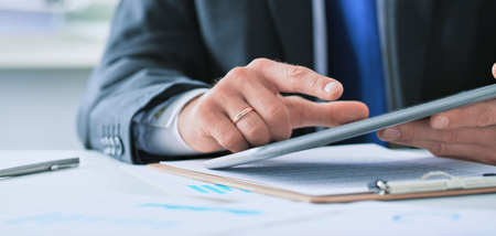 Businessman finger pointing to the screen of a tablet-pc.の写真素材