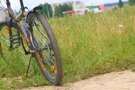 A black bicycle in the panoramic view of green field.の写真素材