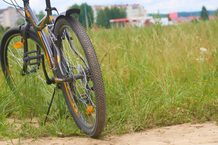 A black bicycle in the panoramic view of green field.の写真素材