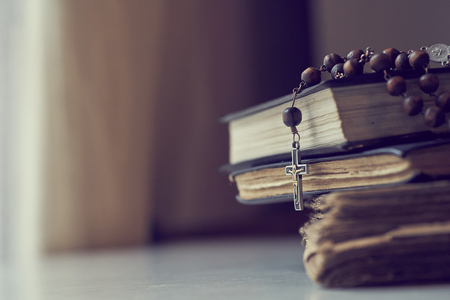 The rosary beads on Catholic Church liturgy books.