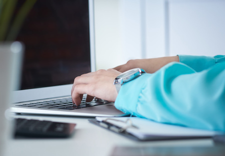 Businesswoman typing on laptop at office workplace Woman working in home office hand keyboard