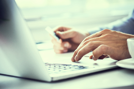 Businessman holding credit card and typing on laptop for online shopping and payment makes a purchase on the Internet.の写真素材