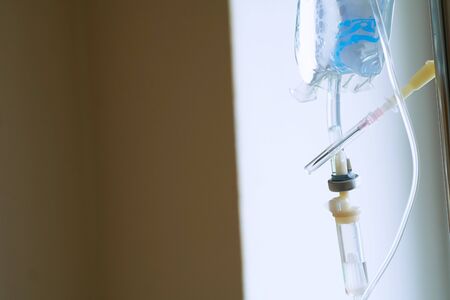 Hospital surgery medical drip in emergency room operating theater ward in medical clinic. Saline solution drip for patient in hospital.の写真素材