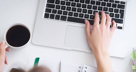 Business, education, people and technology concept - close up of female hands with laptop computer...