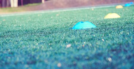 Football chips for training on artificial turf close up.の写真素材