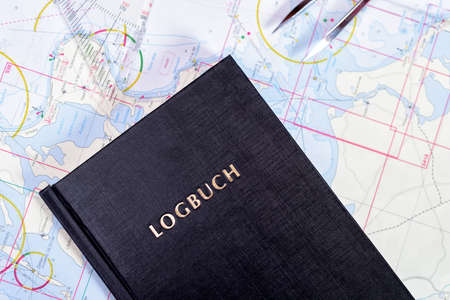 navigation book with sea charts in the chart room on a sailing yachtの写真素材