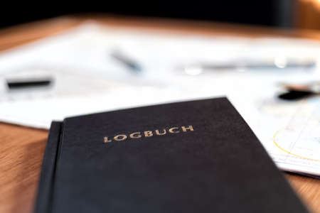 navigation book with sea charts in the chart room on a sailing yachtの写真素材