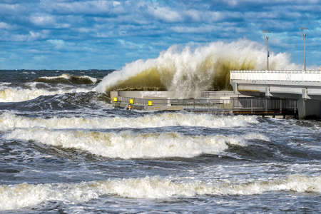 big braking waves during a gale in Kolobrzeg on the coast of the Baltic sea in Polandの写真素材