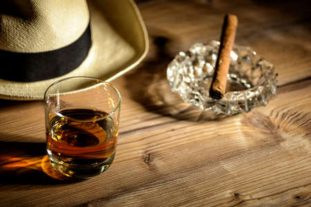 glas of rum, cigar and a panama hat in a bar in Cubaの写真素材