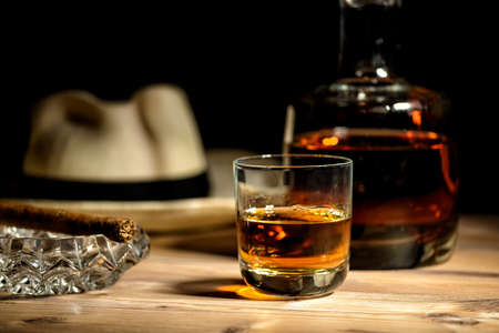 glas of rum, cigar and a panama hat in a bar in Cubaの写真素材