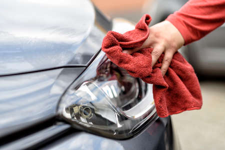 polishing a car with a rag after the car wash