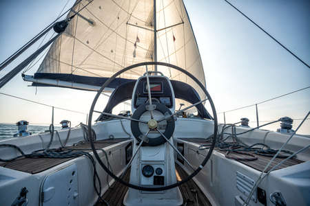 steering wheel in the cockpit of a sailing yachtの写真素材