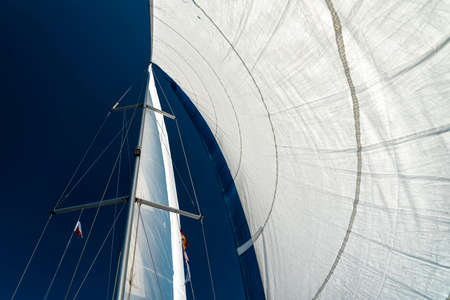 sails of a sailing yacht in the wind sailing on the oceanの写真素材