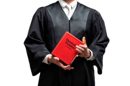 german lawyer with a classical black robe, white tie and bookの写真素材