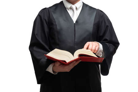 german lawyer with a classical black robe, white tie and bookの写真素材